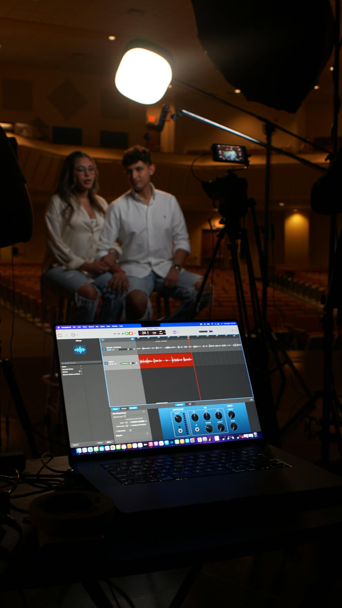 Couple in a studio setting captured with professional video recording equipment.